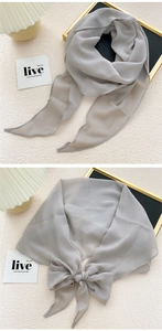 Close-up of light gray chiffon scarf showing delicate texture and elegant knot styles