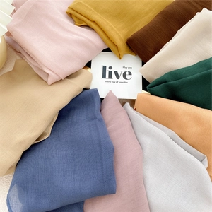 Colorful cotton-linen silk scarves displayed in a sunburst pattern for women's fashion