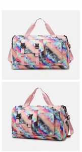 Detailed view of colorful tie-dye travel bag with pink straps and multi-pocket design