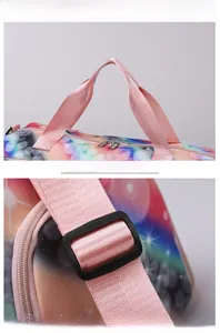Close-up of pink reinforced handles and adjustable shoulder strap on galaxy travel bag
