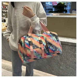 Detail of the colorful gradient travel bag with star pattern and front buckle pockets