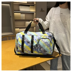 Detail of printed travel bag with multiple pockets on a wooden table setup