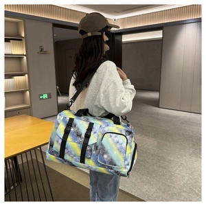 Detail of colorful galaxy print travel bag with adjustable strap and side buckle storage
