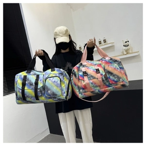 Detail view of large travel bags featuring colorful galaxy prints and functional pockets