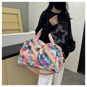 Detail of large travel bag with aurora print, pink handles, and side zipper pockets