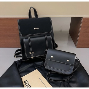 Detail of black PU leather backpack set with white stitching and gold metal buckle