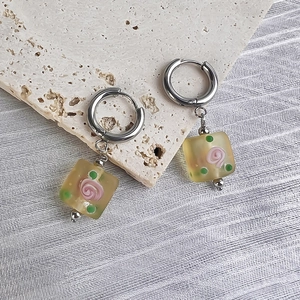 Detailed shot of retro square glass earrings with rose motif on stone and silk
