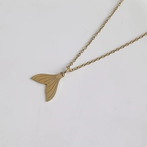 Vue détaillée du pendentif queue de poisson en or 18K avec texture gravée sur chaîne