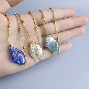 Irregular colored glass leaf pendants on gold-plated titanium steel beaded necklaces