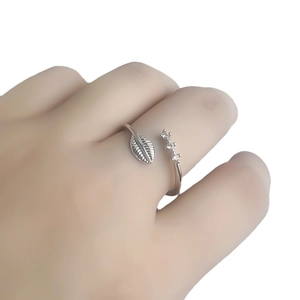 Bague ouverte minimaliste en argent avec feuilles et zircons portée au doigt