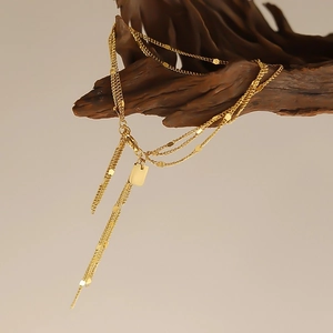 Luxurious layered 18K gold plated titanium steel chain bracelet with metallic tassel charms