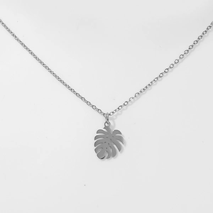Detailed view of silver hollow Monstera leaf pendant on a delicate chain necklace