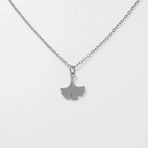 Macro detail of leaf-shaped titanium steel pendant with matte finish on link chain