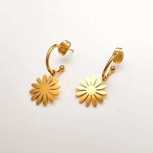 Detail view of 18K gold plated stainless steel daisy pendant hoops on white background