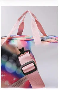 Detail of adjustable pink shoulder strap and rainbow gradient fabric on sports travel bag