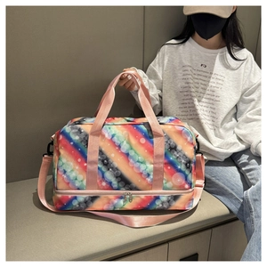 Macro detail of rainbow gradient travel bag with pink handles and shoe compartment