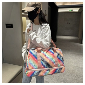 Detail of colorful rainbow polka dot travel bag showing independent bottom zipper compartment