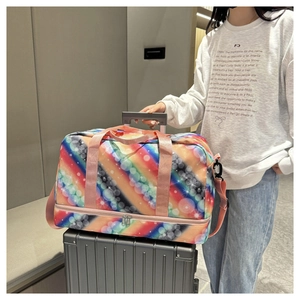 Rainbow striped travel bag with separate bottom shoe compartment on a suitcase