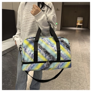 Detail view of large travel bag with yellow bubble print and bottom shoe compartment