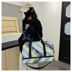 Detail of large travel bag with bottom shoe compartment and colorful patterned fabric
