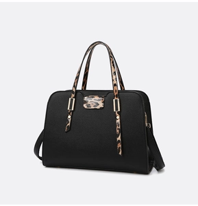 Close-up of black litchi texture leather with leopard print handle and gold hardware