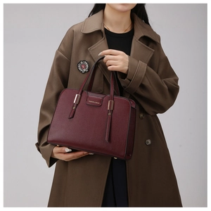 Close-up of burgundy lychee pattern tote bag featuring gold FASHION & BAGS metal hardware