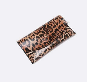 Close-up of leopard print envelope wallet featuring glossy finish and gold button detail