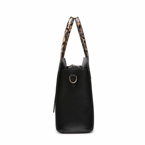 Minimalist black pebbled leather tote bag with stylish leopard print handles in side view