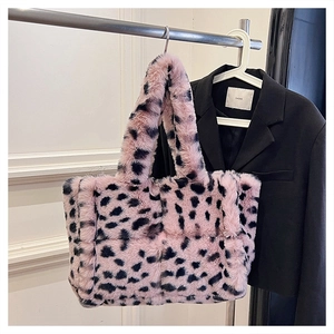 Detail of pink and black leopard plush tote bag with thick handles and quilted texture