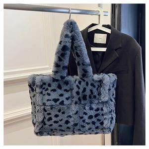 Close-up of blue leopard print faux fur tote bag showing soft plush texture and wide strap