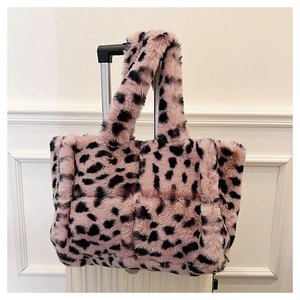 Close-up of pink leopard print plush handbag showing quilted texture and soft faux fur
