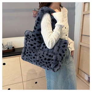 Detail shot of the plush leopard print tote bag with a soft faux fur texture and wide strap