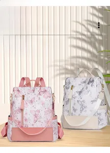 Detail showing two butterfly print backpacks in pink and white with anti-theft design