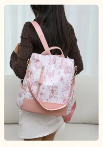 Close-up of pink butterfly print backpack with golden zippers and durable fabric