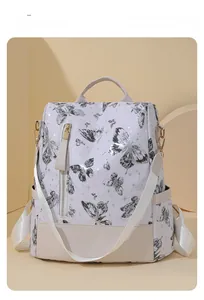 Detail of butterfly print backpack showing seven-hole adjustable beige leather straps