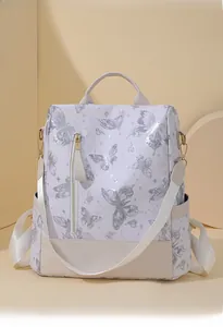 Detail of butterfly print backpack with golden zippers and adjustable straps for women