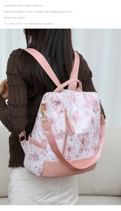 Detail of pink butterfly print backpack showing thick straps and golden metal buckles