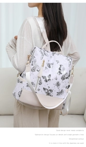 Detail of butterfly print backpack with adjustable straps and front zipper pocket