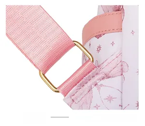 Detail of pink backpack strap connection with golden metal buckle and butterfly print