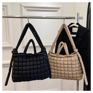 Sacs cabas matelassés noir et beige montrant la texture douce et le ruban élégant