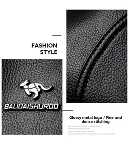 Close-up of black lychee grain leather handbag with gold kangaroo logo and fine stitching
