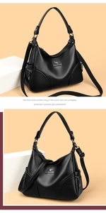Detailed close-up of black lychee grain leather tote with metal kangaroo logo and handles