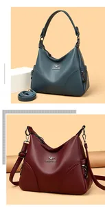 Detailed view of lychee pattern leather handbag featuring golden logo and textured finish