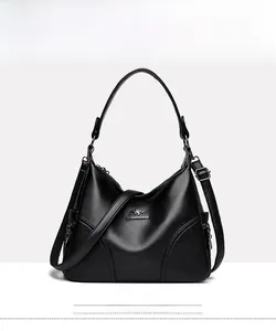 Front view of large black lychee textured leather tote with golden kangaroo logo and strap