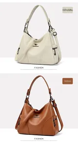 Detail view of large leather hobo bags in cream and caramel with metal kangaroo logo