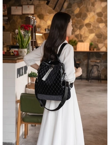 Close-up of black velvet backpack featuring quilted patterns and sequin details