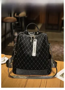 Detail of black quilted backpack featuring sparkling rhinestones and crystal bottom band