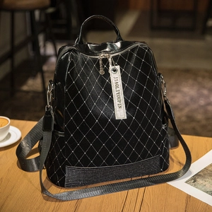 Chic black quilted leather backpack with sparkling rhinestones and adjustable nylon straps