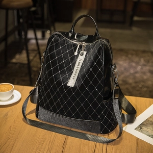 Fashionable black quilted leather backpack with sparkling studs and diamond accents