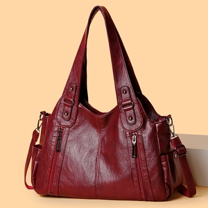 Vintage burgundy faux leather tote bag with decorative metal zippers and shoulder straps
